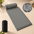 Acupressure mat and pillow set with lotus flower-shaped spikes, grey fabric, and storage bag.