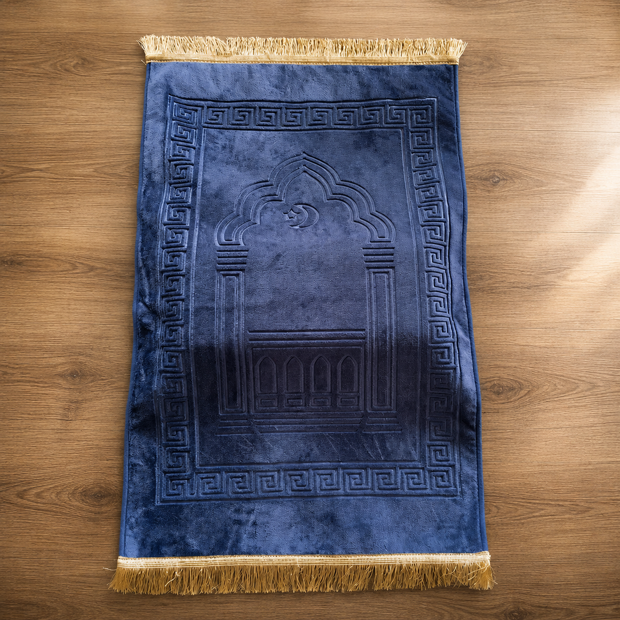 Deep blue Islamic prayer mat with traditional geometric border and arch design.