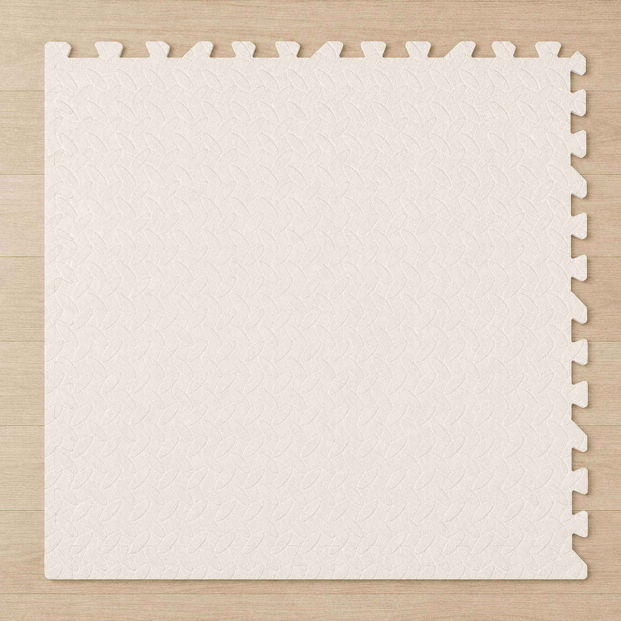Cream interlocking puzzle mat with a textured surface, shown on a wooden floor.