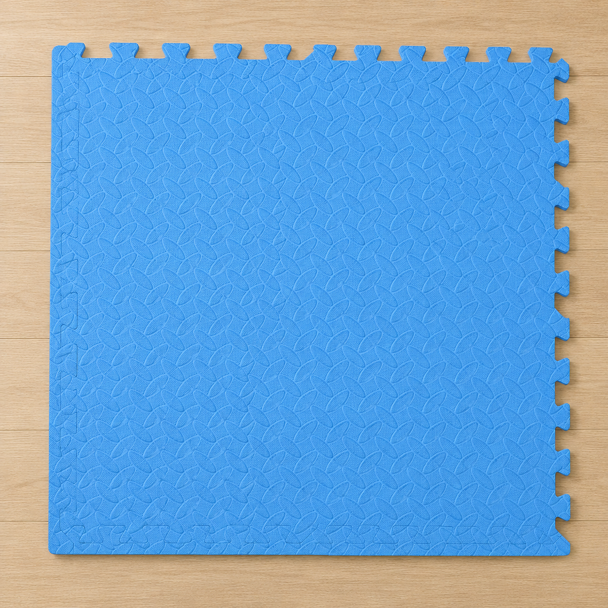 Blue interlocking foam puzzle mat with a textured surface on a light wood floor.