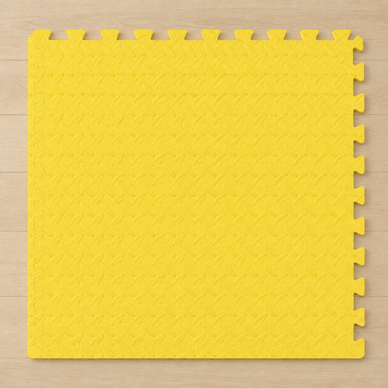 Yellow interlocking foam floor mat with diamond pattern, on a wooden floor.