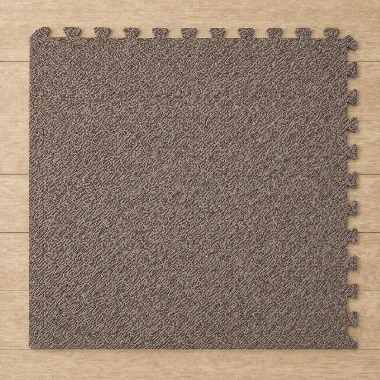 Brown interlocking foam floor mat with a textured diamond pattern, on a light wood floor.