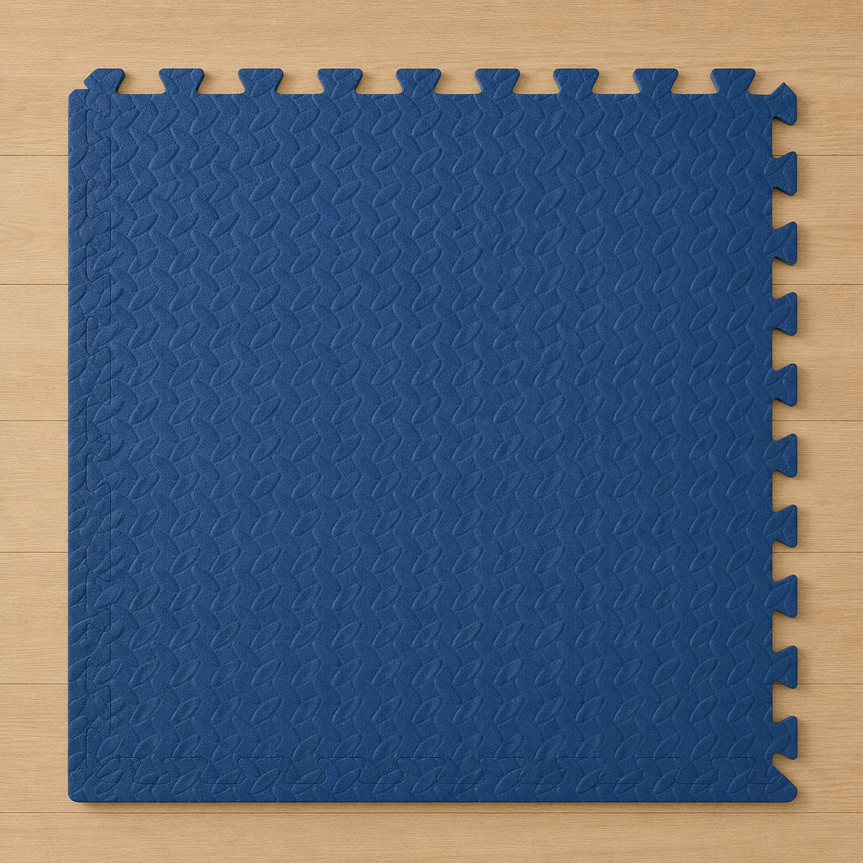 Blue interlocking foam puzzle mat with a textured surface on a light wood floor.