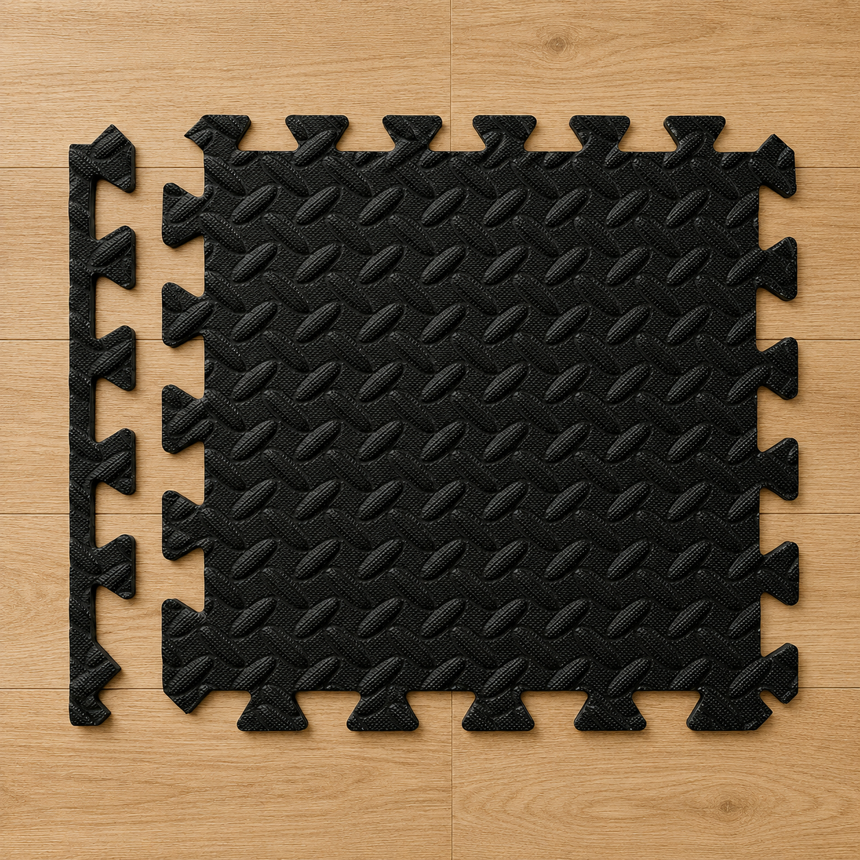 Black interlocking gym mat pieces arranged on a wooden floor.