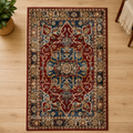 Deep red and blue oriental rug with intricate medallion pattern on a light wood floor.
