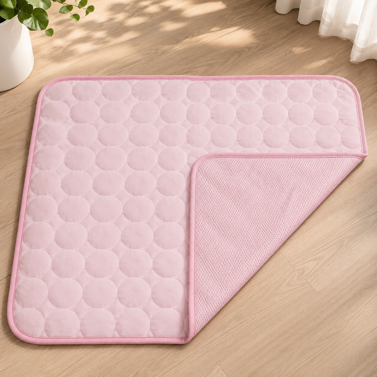 Pink cooling mat for dogs with a quilted circle pattern and a textured underside.