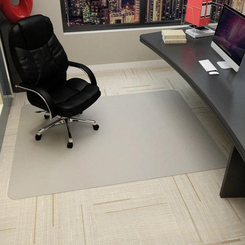 Clear office chair mat protecting beige carpet from a black executive chair.