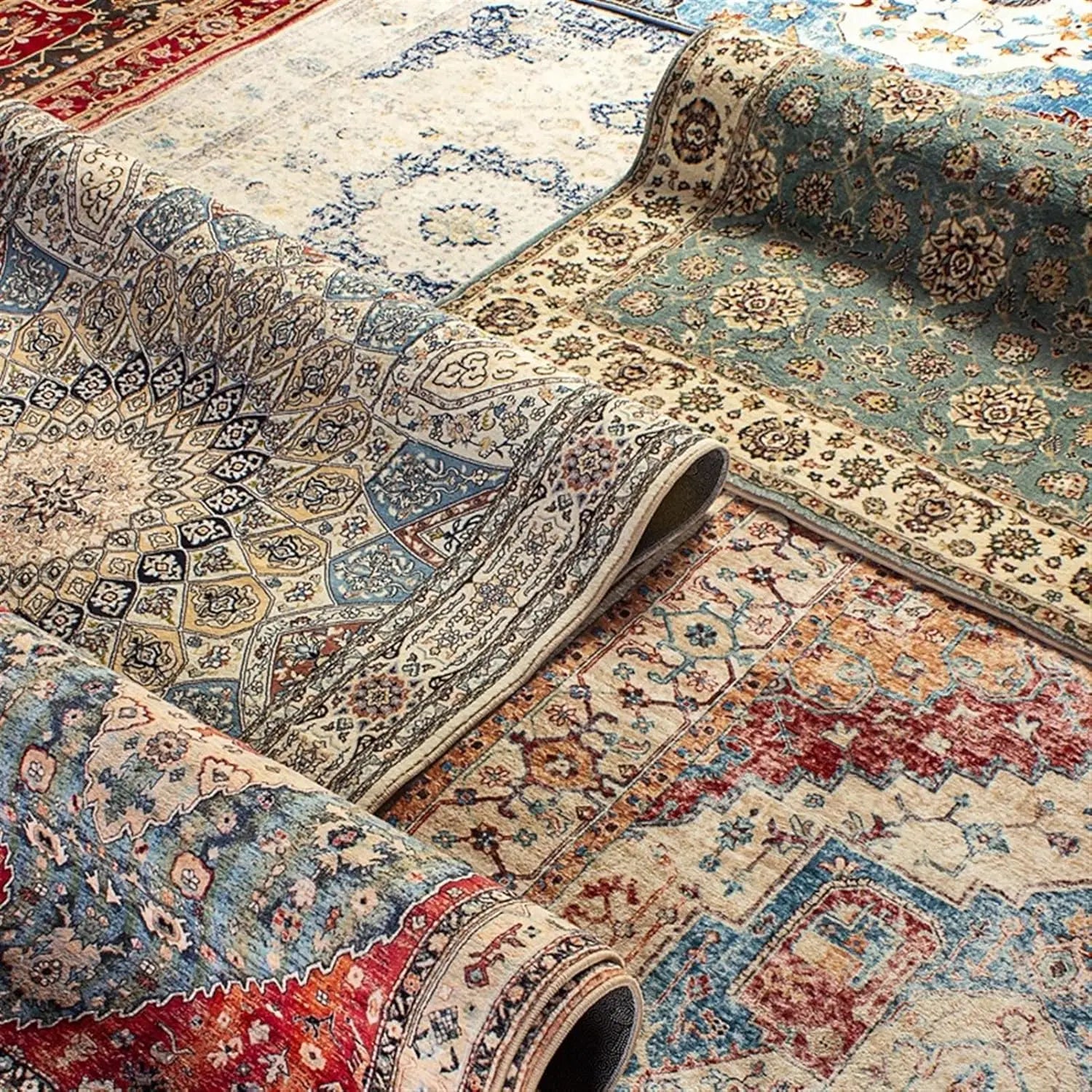 Tapis oriental rouge with intricate traditional patterns, rolled and displayed with other Persian rugs.