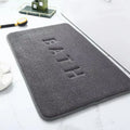 Soft grey bath mat with "BATH" embossed on the surface.