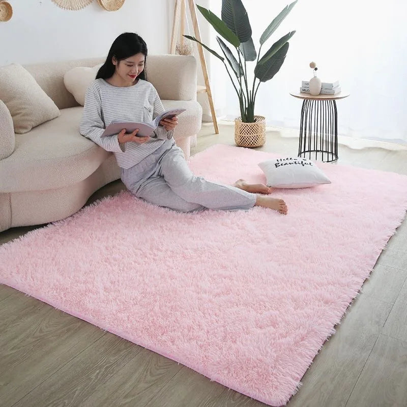 Soft pink fluffy rug for children's room, with a woman reading on a sofa.
