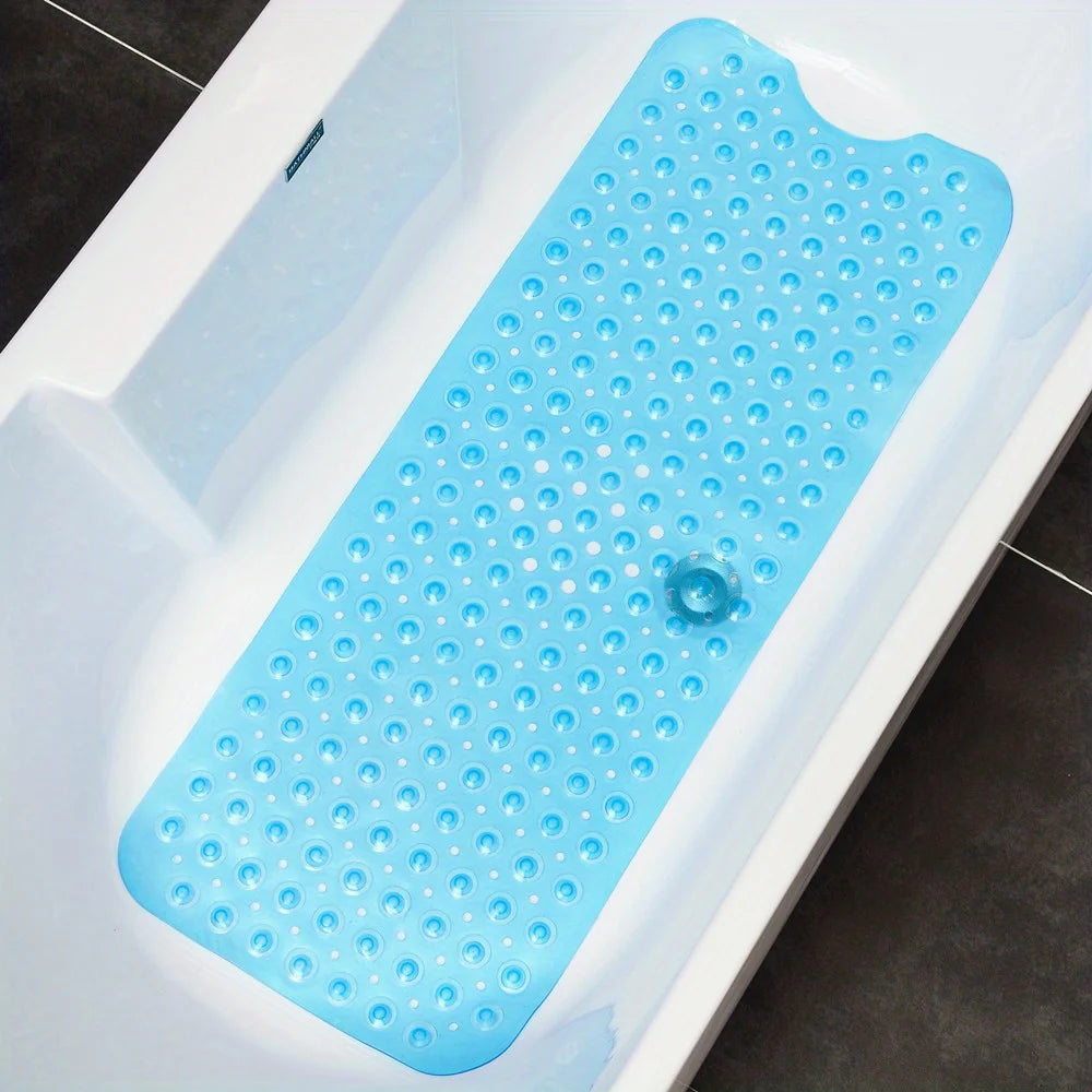 Blue non-slip bath mat with suction cups inside a white bathtub.
