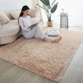 Soft beige plush rug in a bedroom with a young woman reading on the floor.