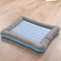 Blue cooling mat for cats with striped bolster, resting on a wooden floor.