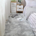 Plush grey bedroom rug with soft shag texture, complementing a modern interior design.