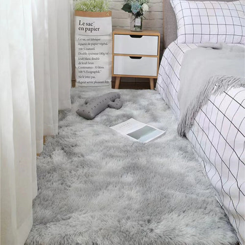 Plush grey bedroom rug with soft shag texture, complementing a modern interior design.