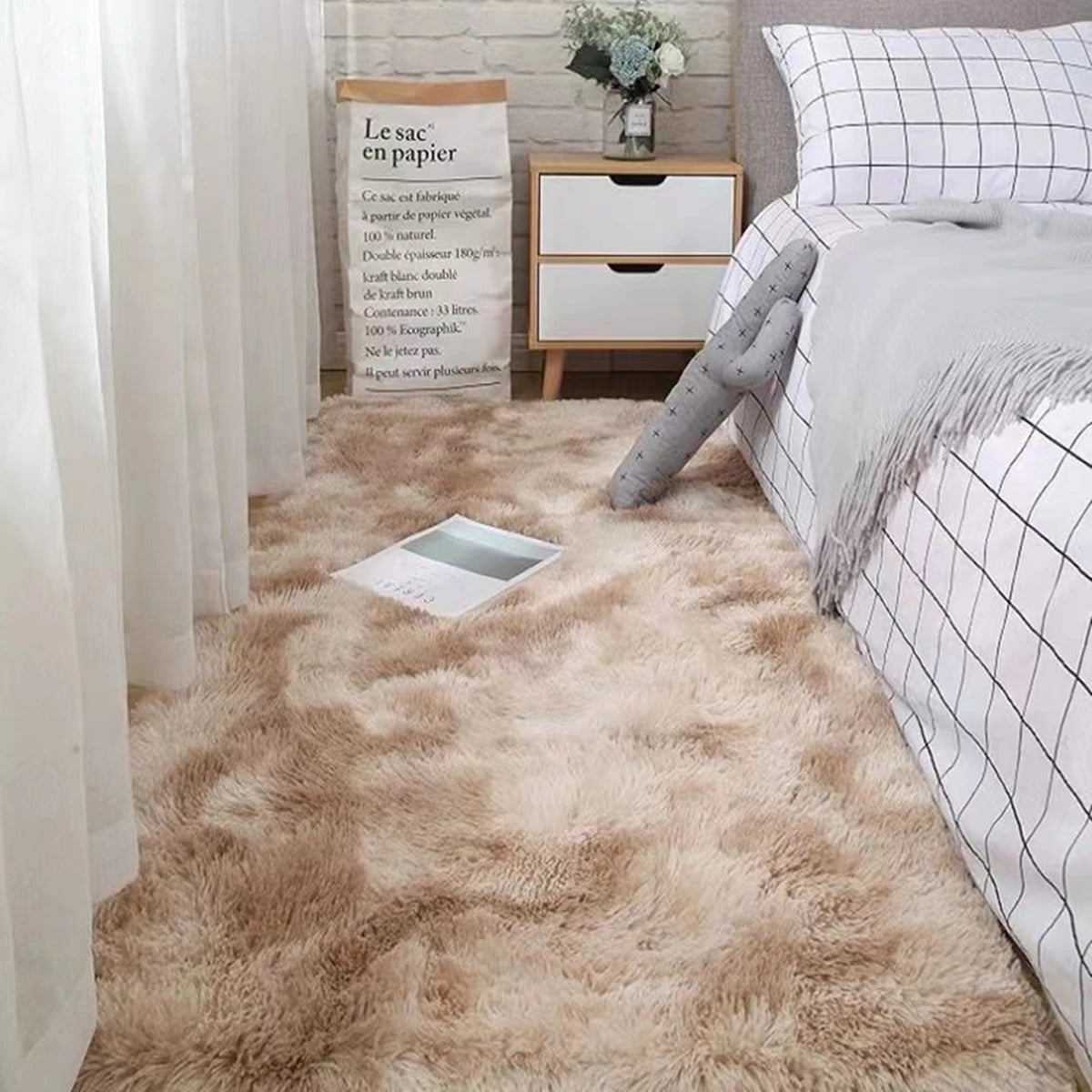 Plush beige bedroom rug with a soft, shaggy texture in a cozy bedroom setting.