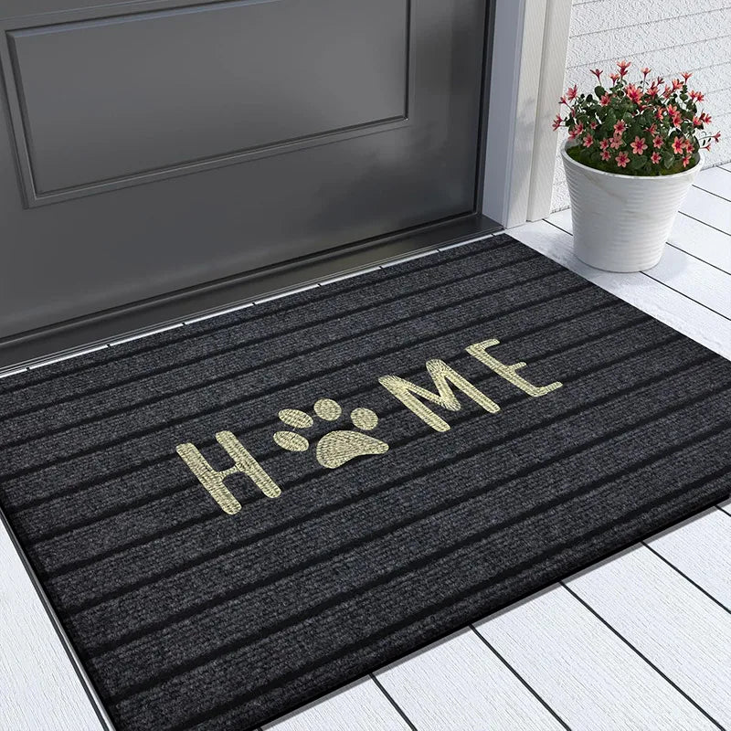 Black entryway doormat with "HOME" and paw print design.