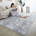 Fluffy grey bedroom rug with a soft texture, featuring a woman reading on a couch.