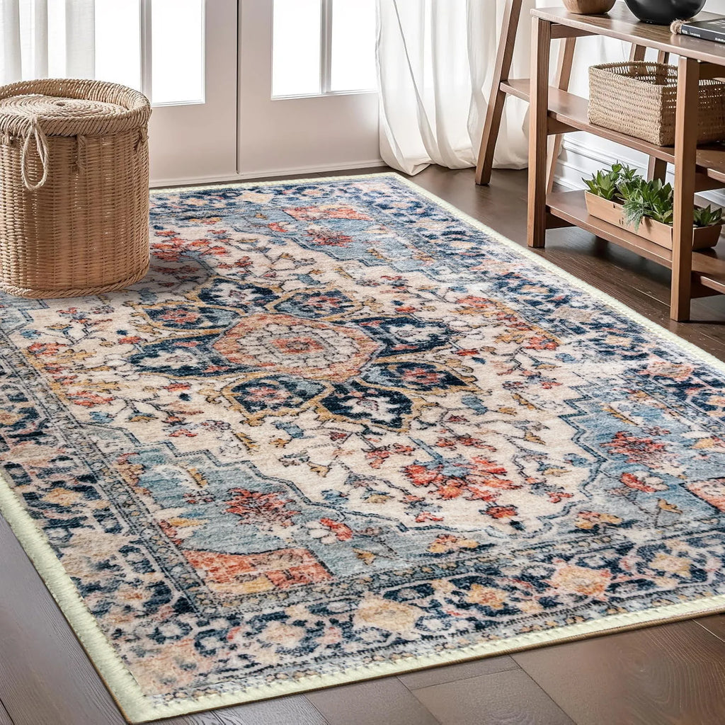Cream and blue Persian-style area rug with distressed floral medallion pattern.
