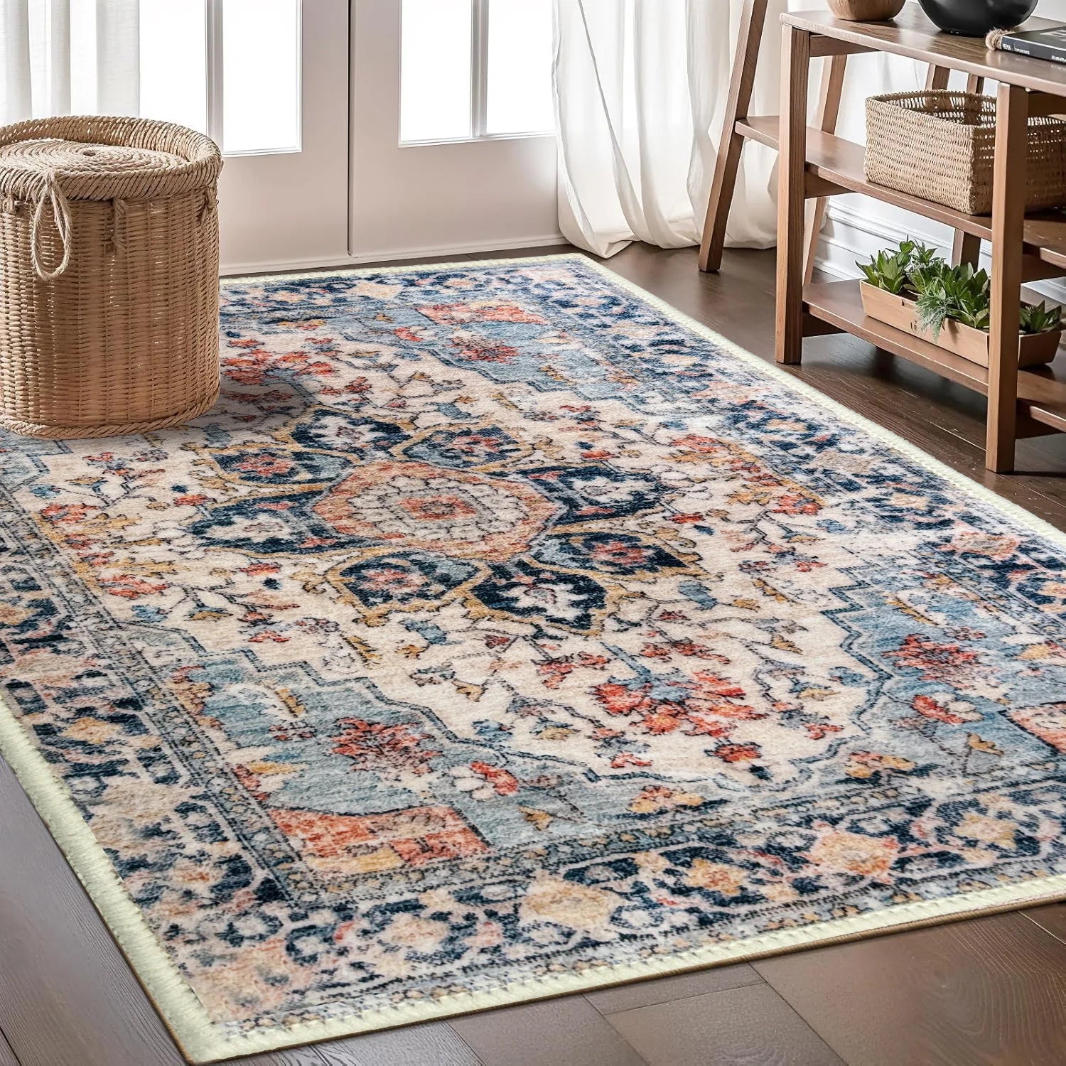 Cream and blue Persian-style area rug with distressed floral medallion pattern.