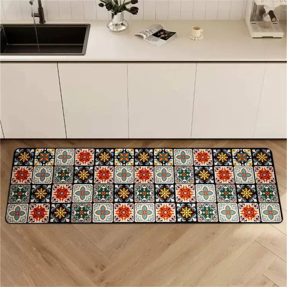 Colorful patterned kitchen runner rug with a mosaic tile design, laid in front of white kitchen cabinets.
