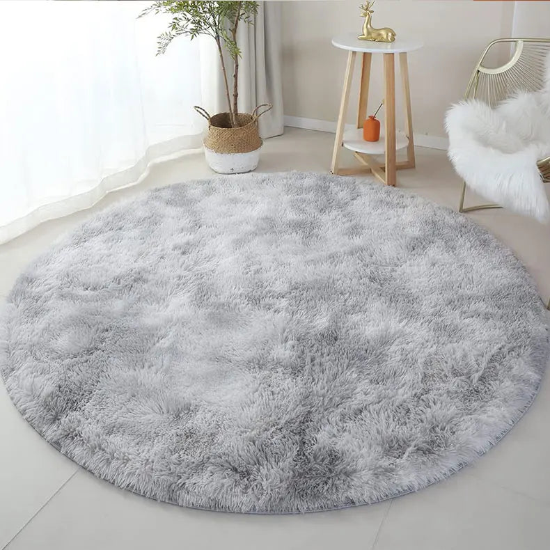 Fluffy grey round rug for living room, soft and cozy shag carpet.