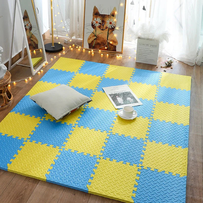 Blue and yellow interlocking foam puzzle mat tiles arranged in a checkerboard pattern on a wooden floor.