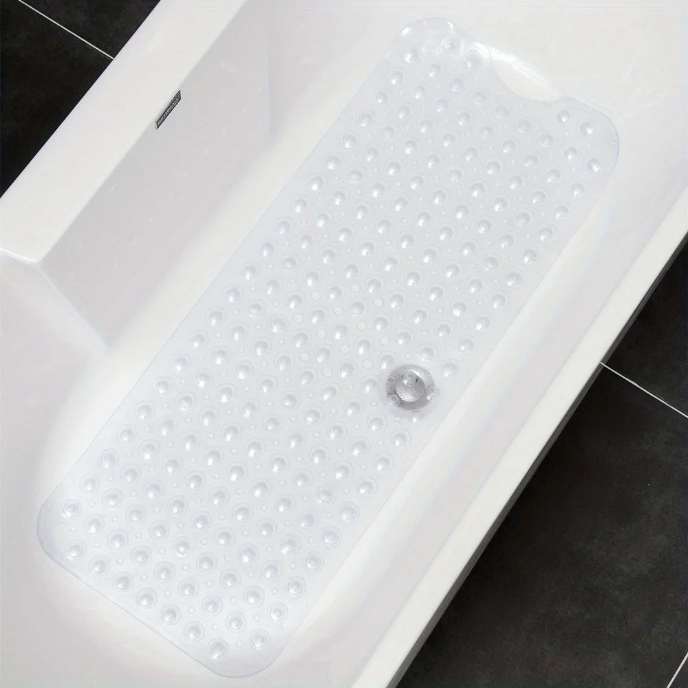 Clear textured non-slip bath mat with suction cups laid flat in a white bathtub.