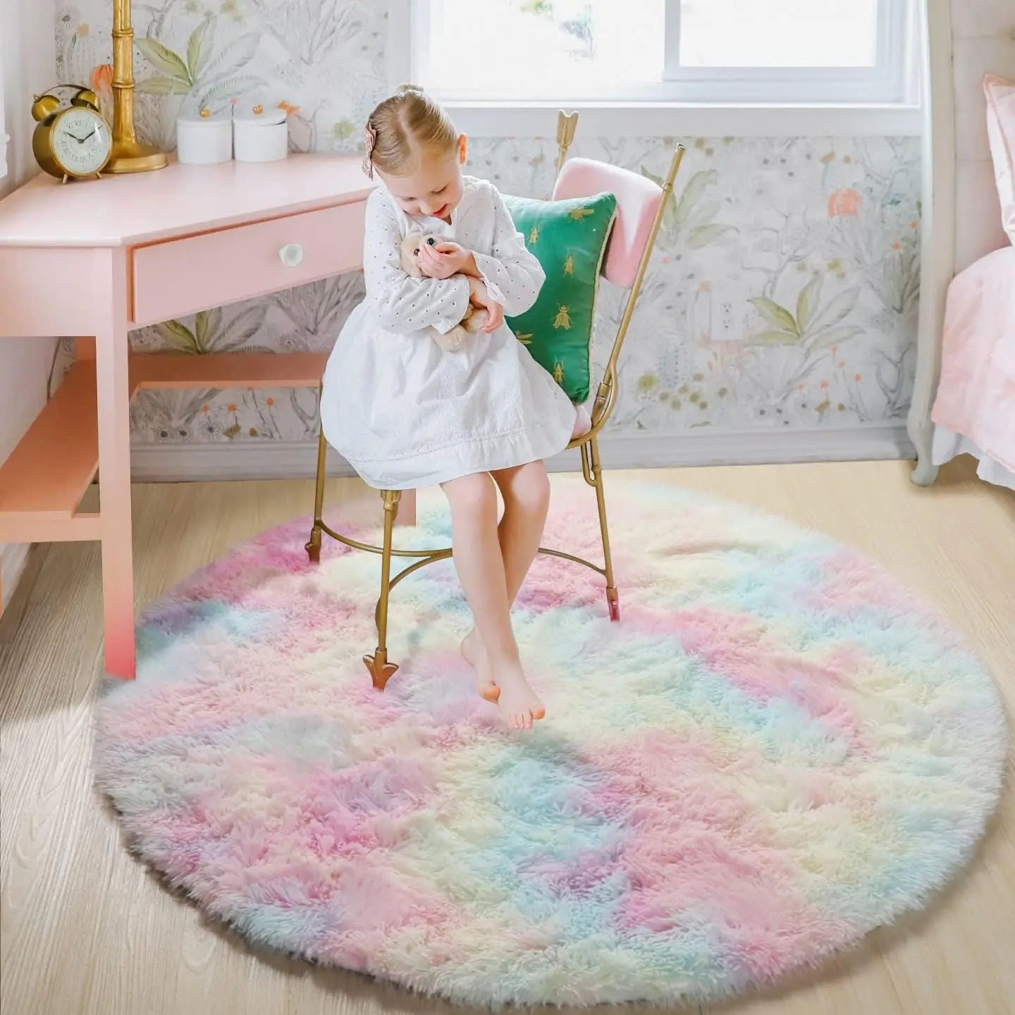 Fluffy round rug with pastel tie-dye colors in a child's bedroom.