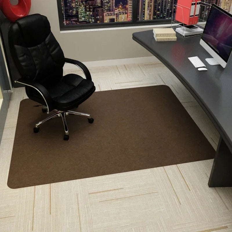 Brown office chair mat protecting a carpeted floor under a desk.