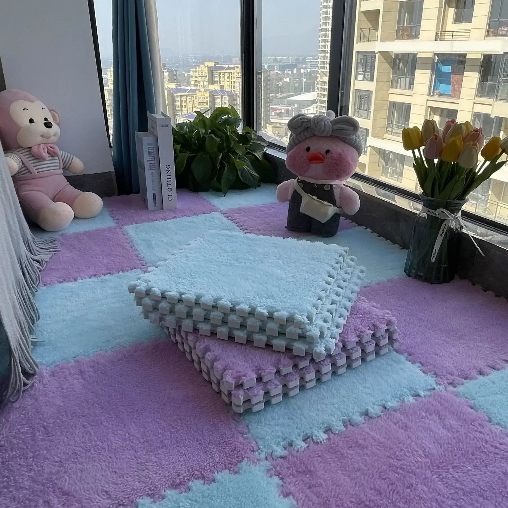 Soft, interlocking puzzle mats in pastel pink and blue, creating a cozy floor space.
