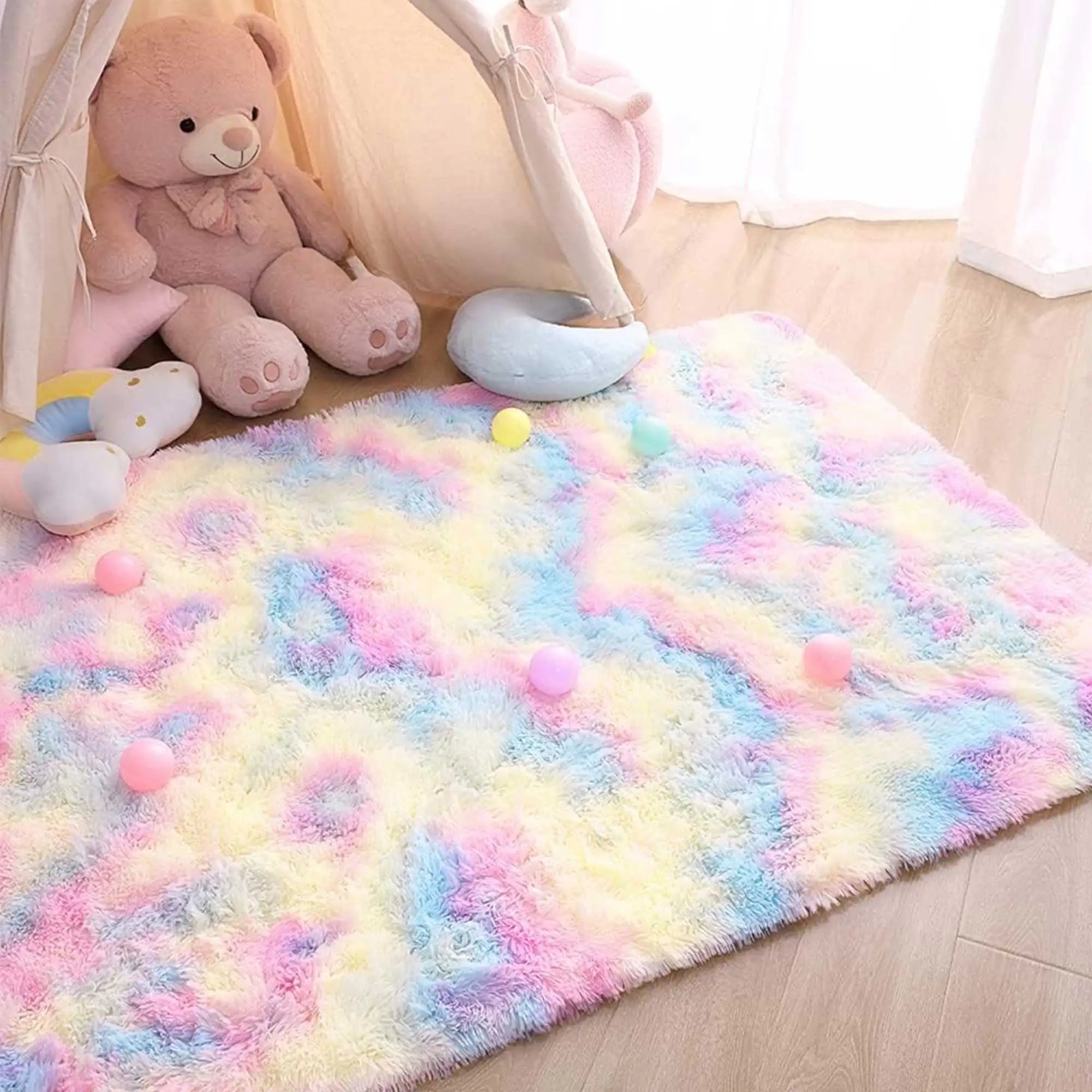 Soft, fluffy children's room rug with a pastel rainbow tie-dye pattern, featuring a teddy bear and play tent.