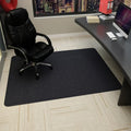 Black office chair mat on a carpeted floor in front of a desk.
