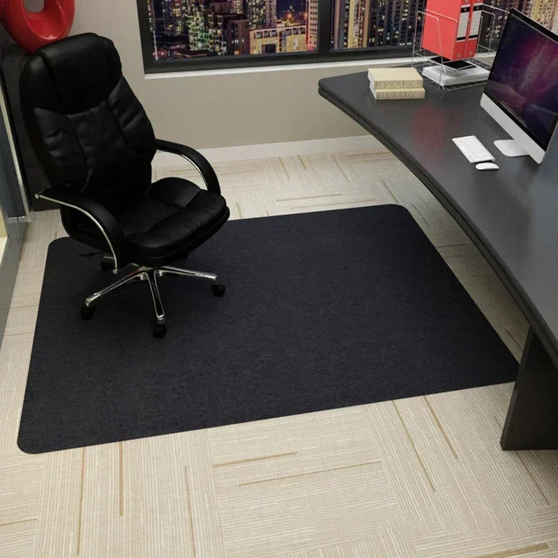 Black office chair mat on a carpeted floor in front of a desk.