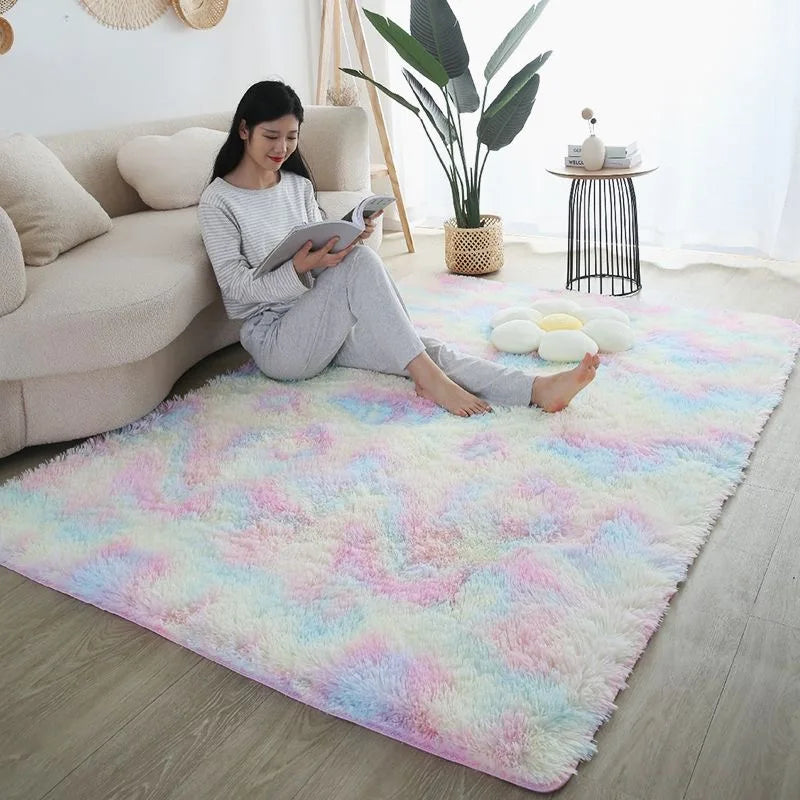 Fluffy rainbow tie-dye rug in a child's bedroom with a young woman reading.