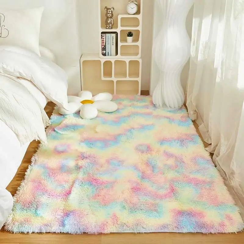 Soft, fluffy rainbow rug for a child's bedroom with a flower pillow.